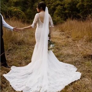 Elegant Ivory Lace Bridal Gown with Long Train